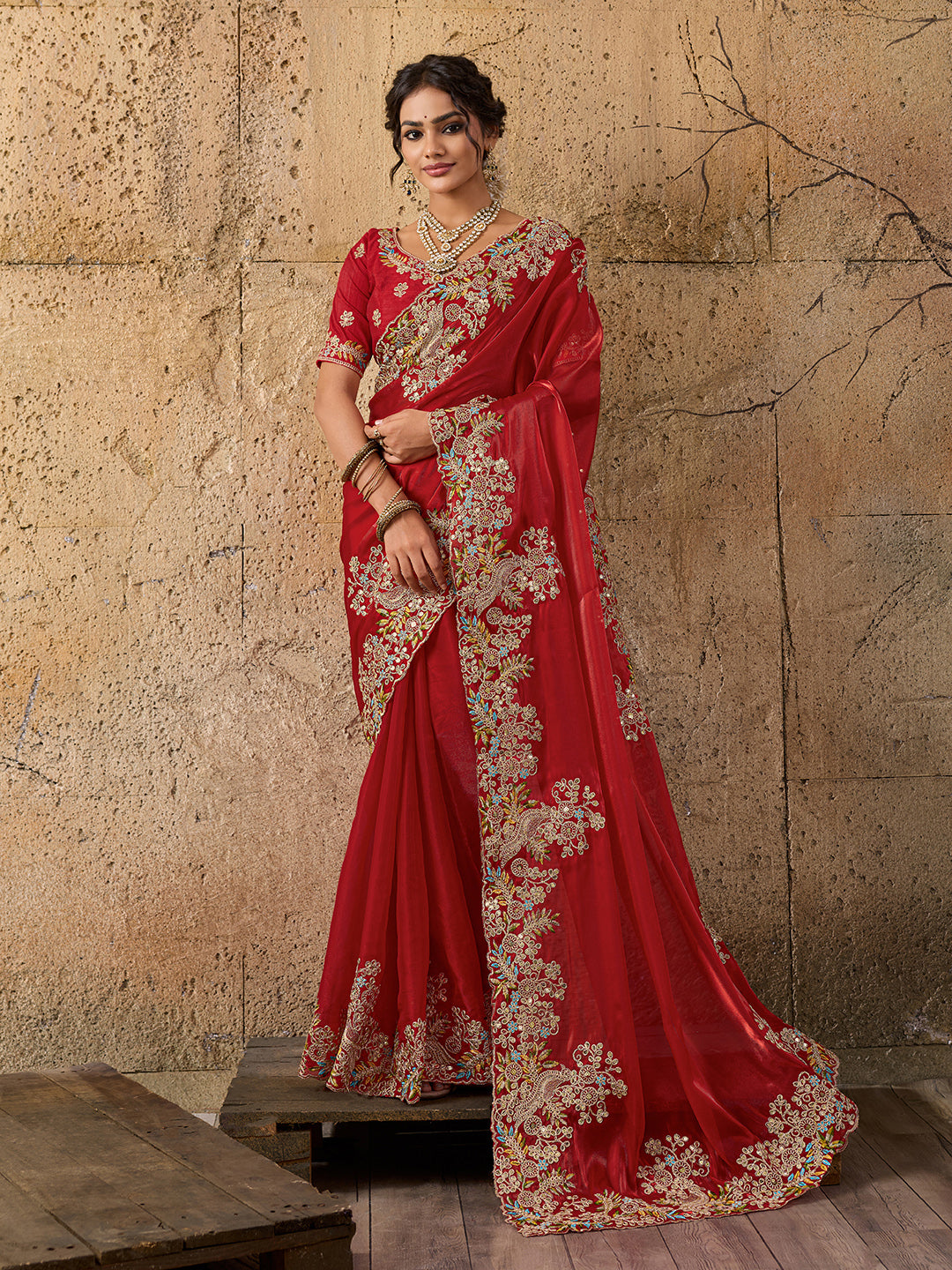 A red saree with floral embroidery