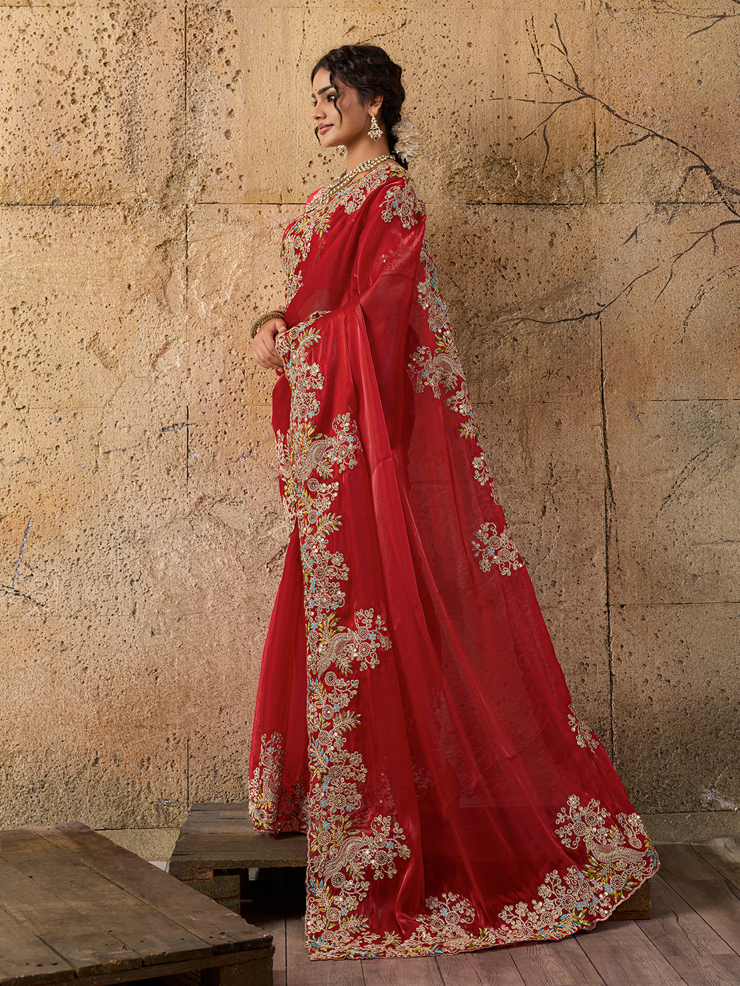 A red saree with floral embroidery