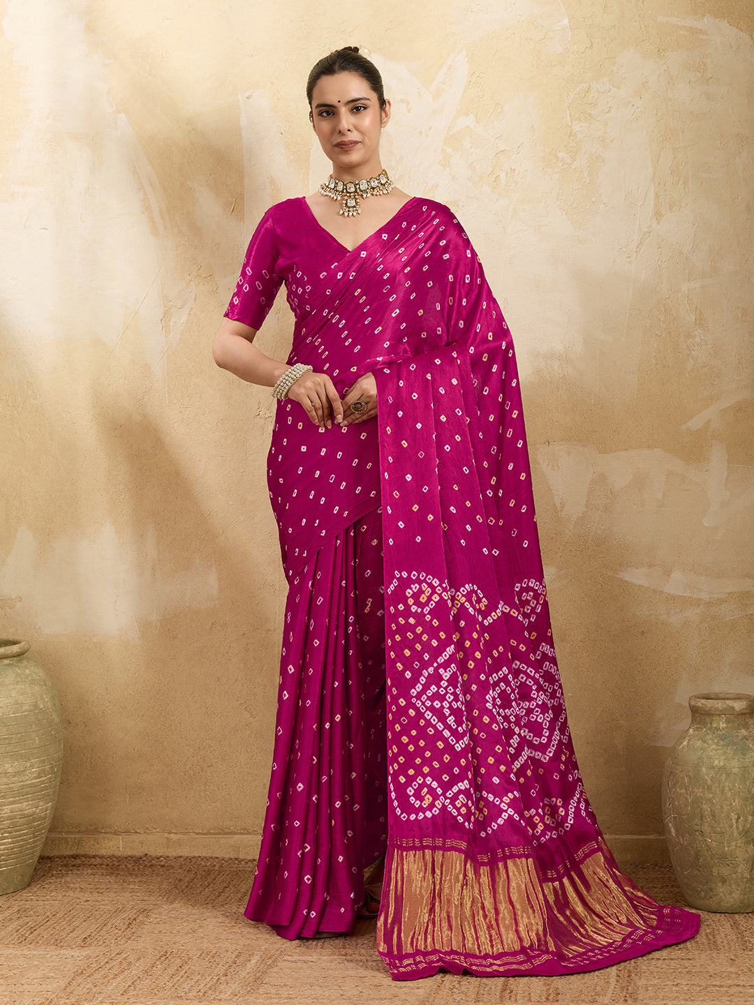 A pink saree with a bandhani pattern and a lagdi pallu design,