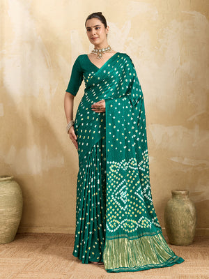 A traditional saree with a bandhani pattern in teal color,