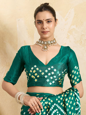 A traditional saree with a bandhani pattern in teal color,