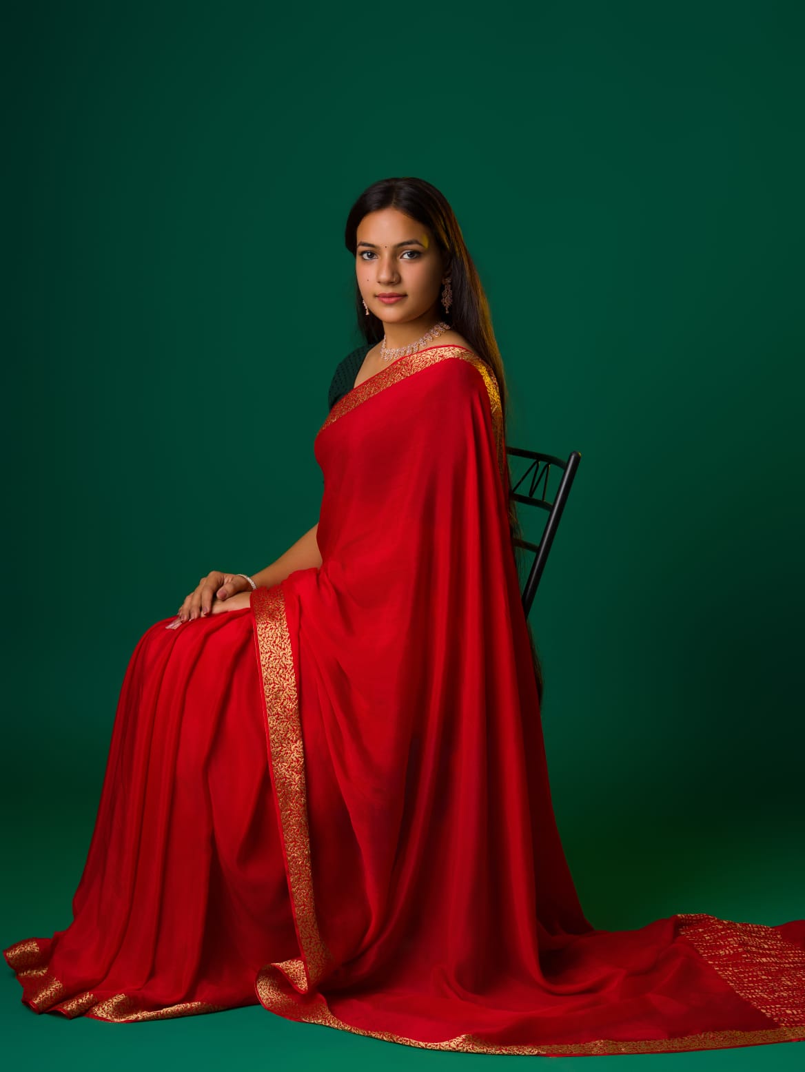A red saree with a zari border