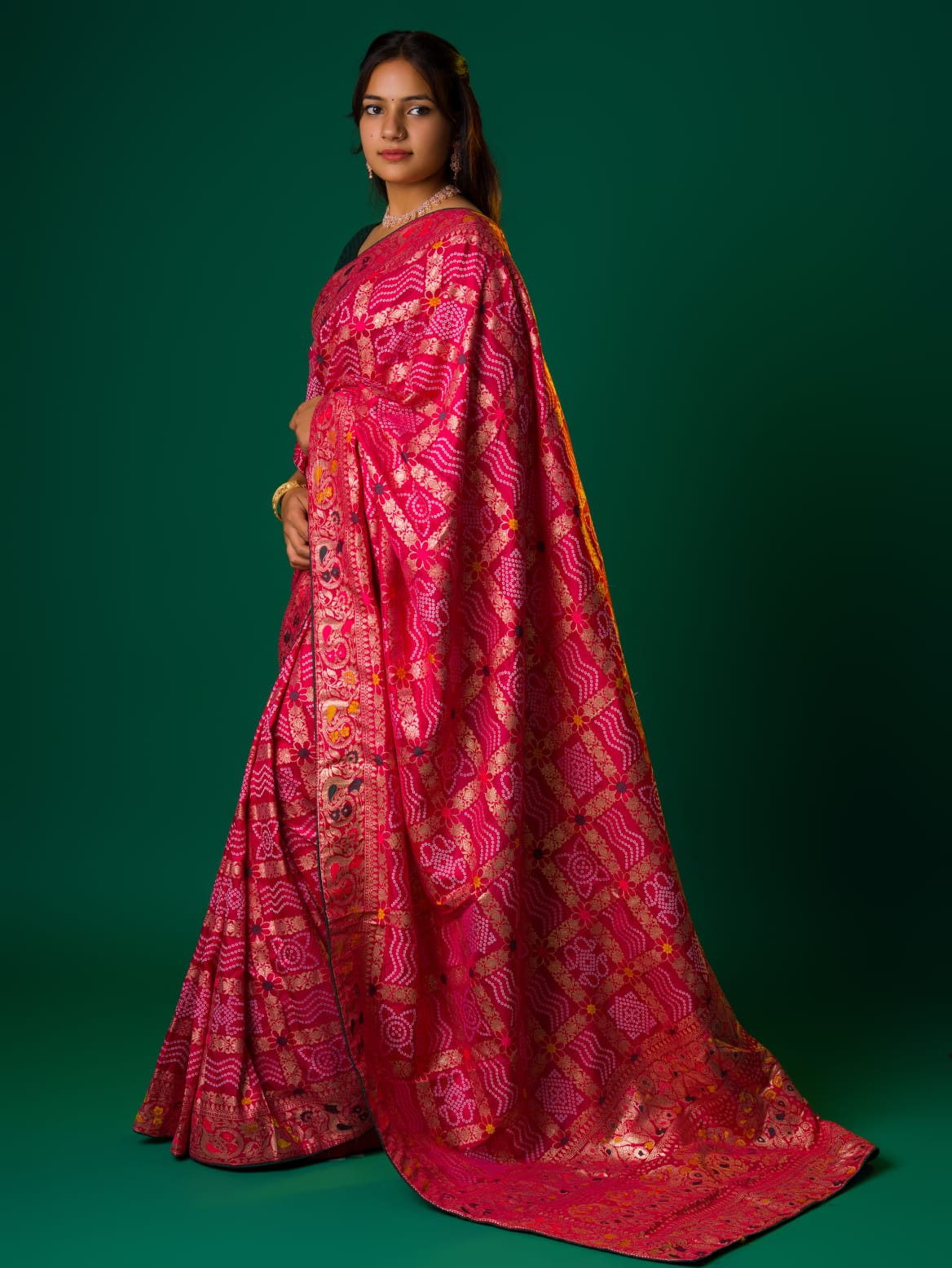 A pink and multicolor bandhani style saree