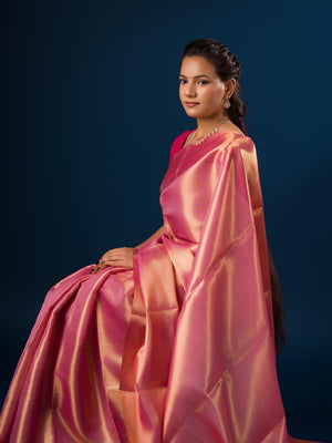 A pink and golden Banarasi silk saree with tissue pattern