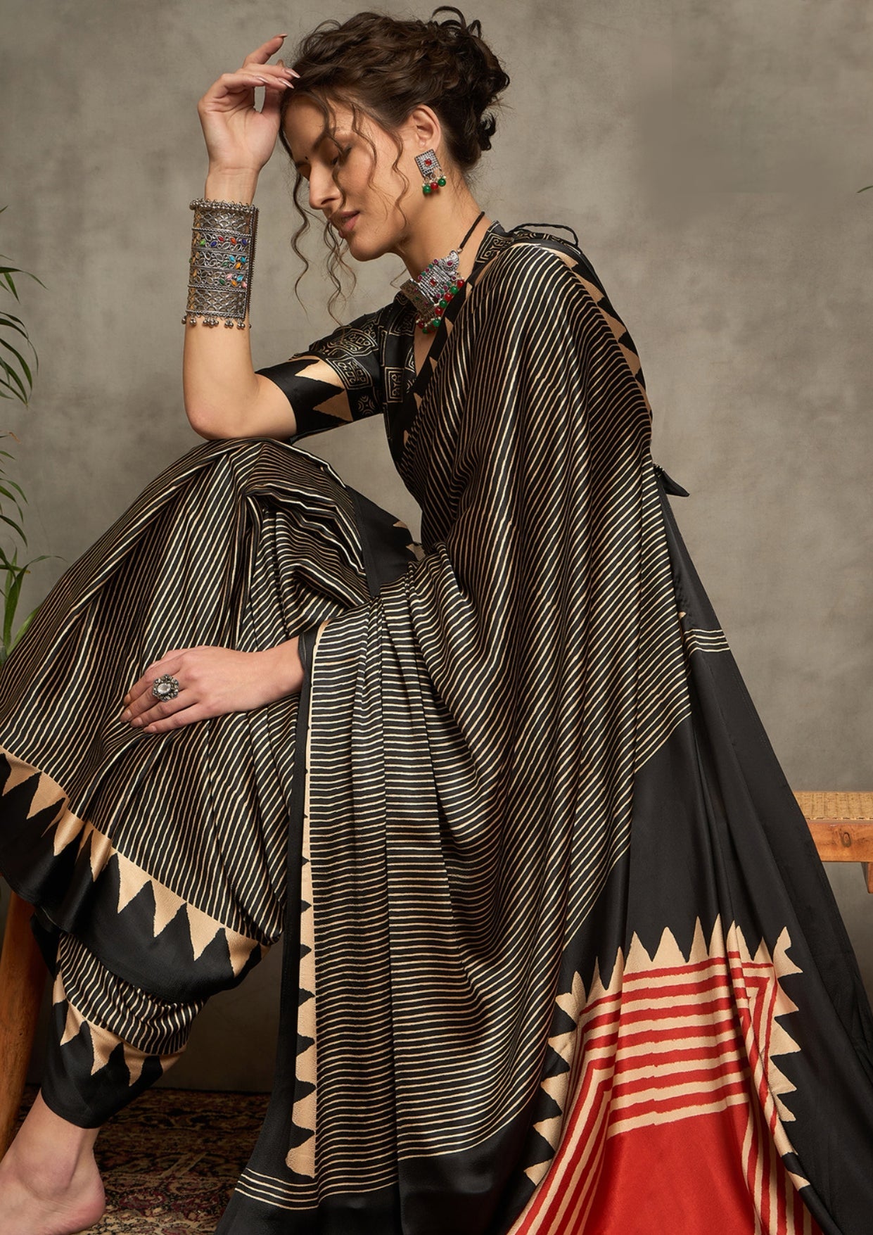 A black and gray silk saree with a geometric ajrakh print