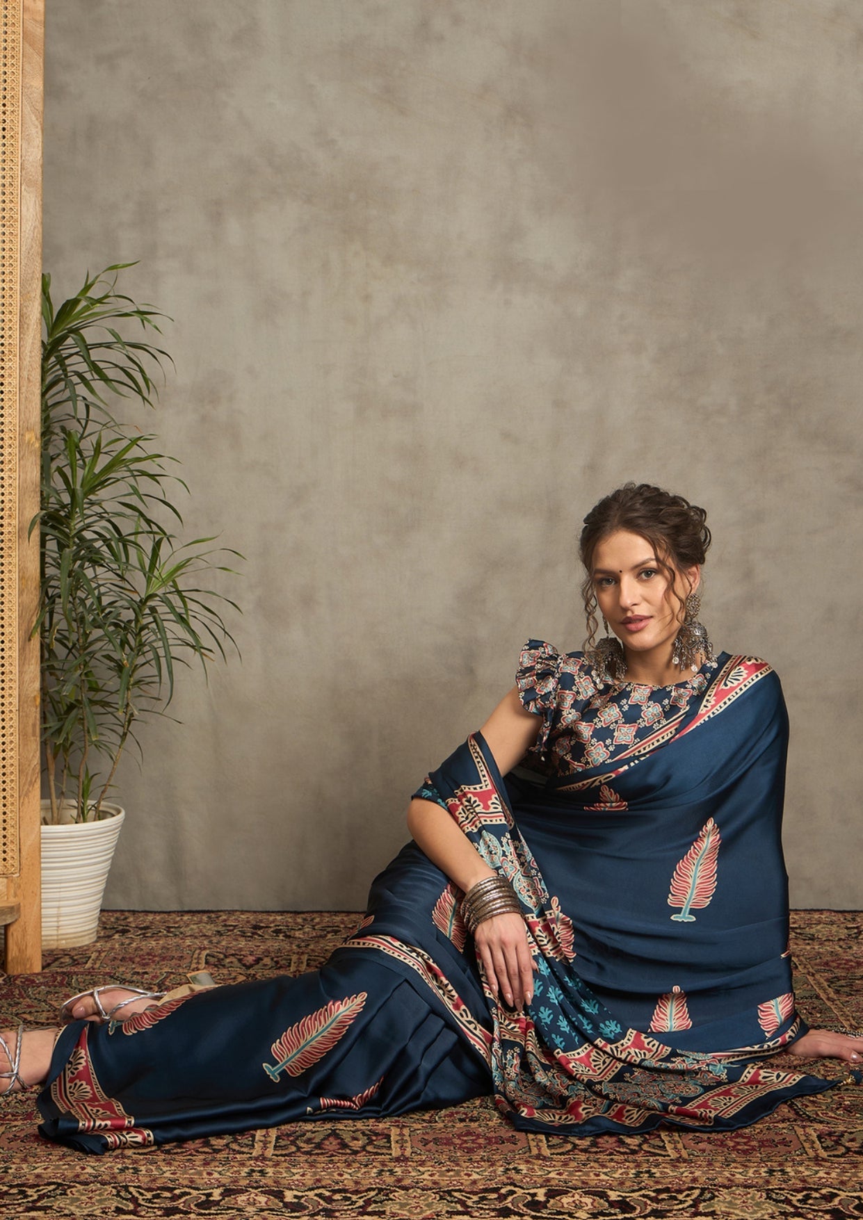 A blue saree with red and white floral ajrak print