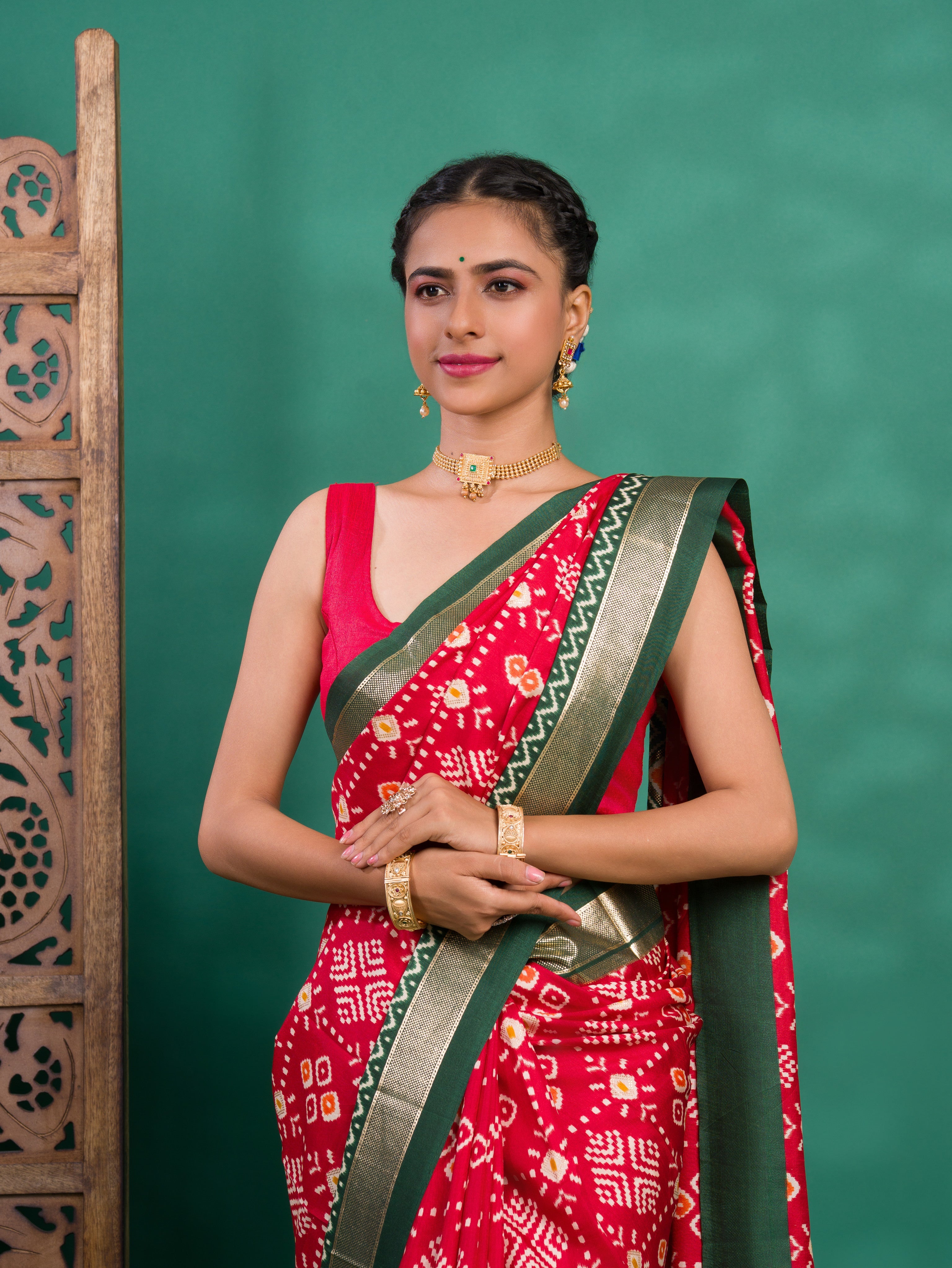 A green and red pashmina cotton silk saree with a patola style pattern