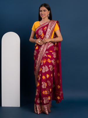 A maroon saree with gold patterns with Dola Silk Bandhani Zari Weaving Work