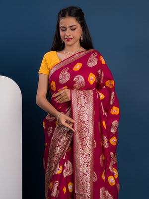 A maroon saree with gold patterns with Dola Silk Bandhani Zari Weaving Work