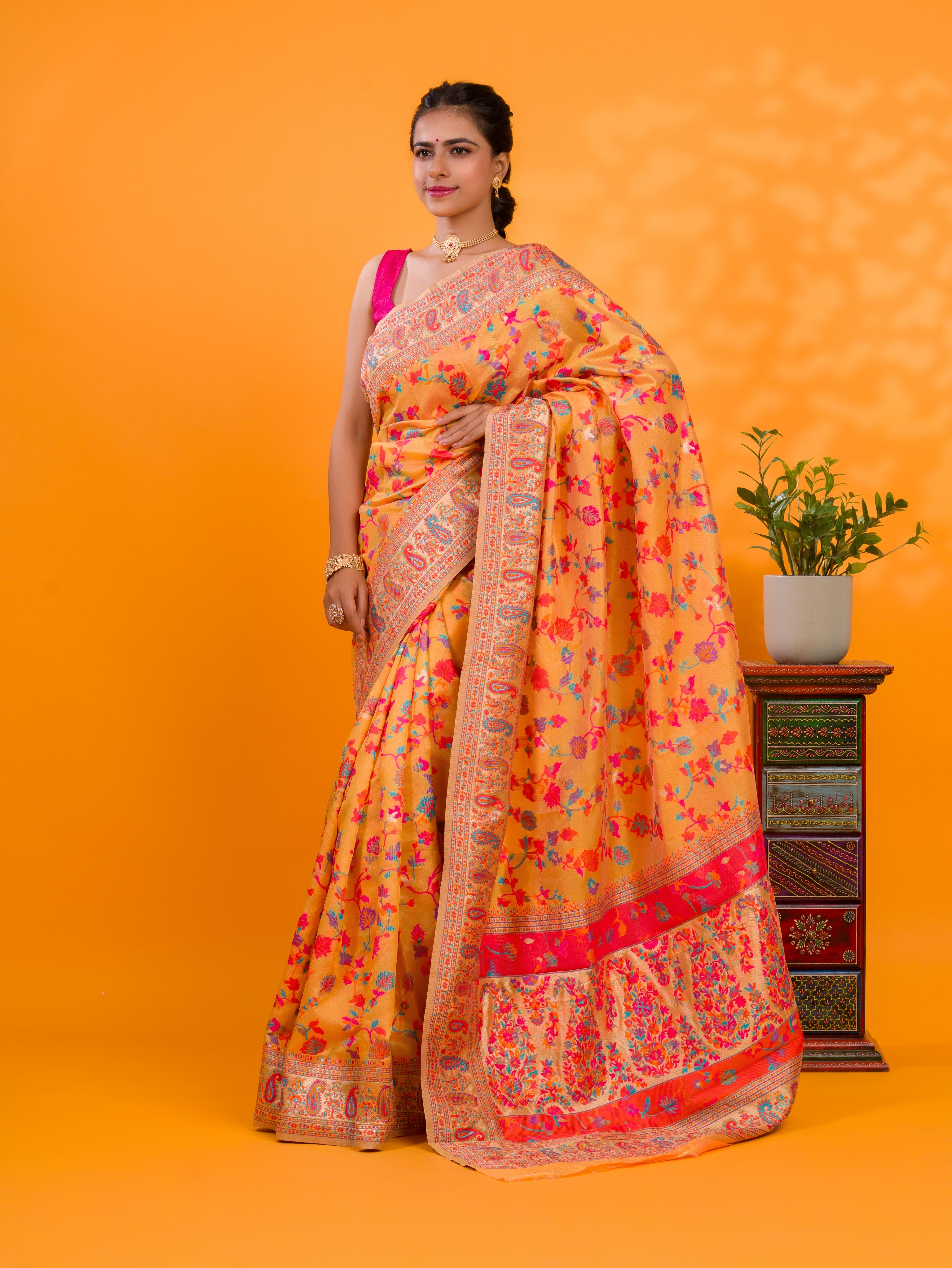 A yellow cotton silk saree with Kashmiri style patterns and Meenakari weaving work.