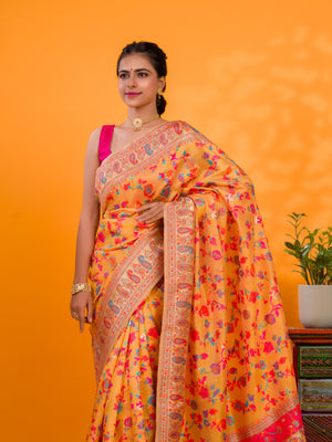 A yellow cotton silk saree with Kashmiri style patterns and Meenakari weaving work.