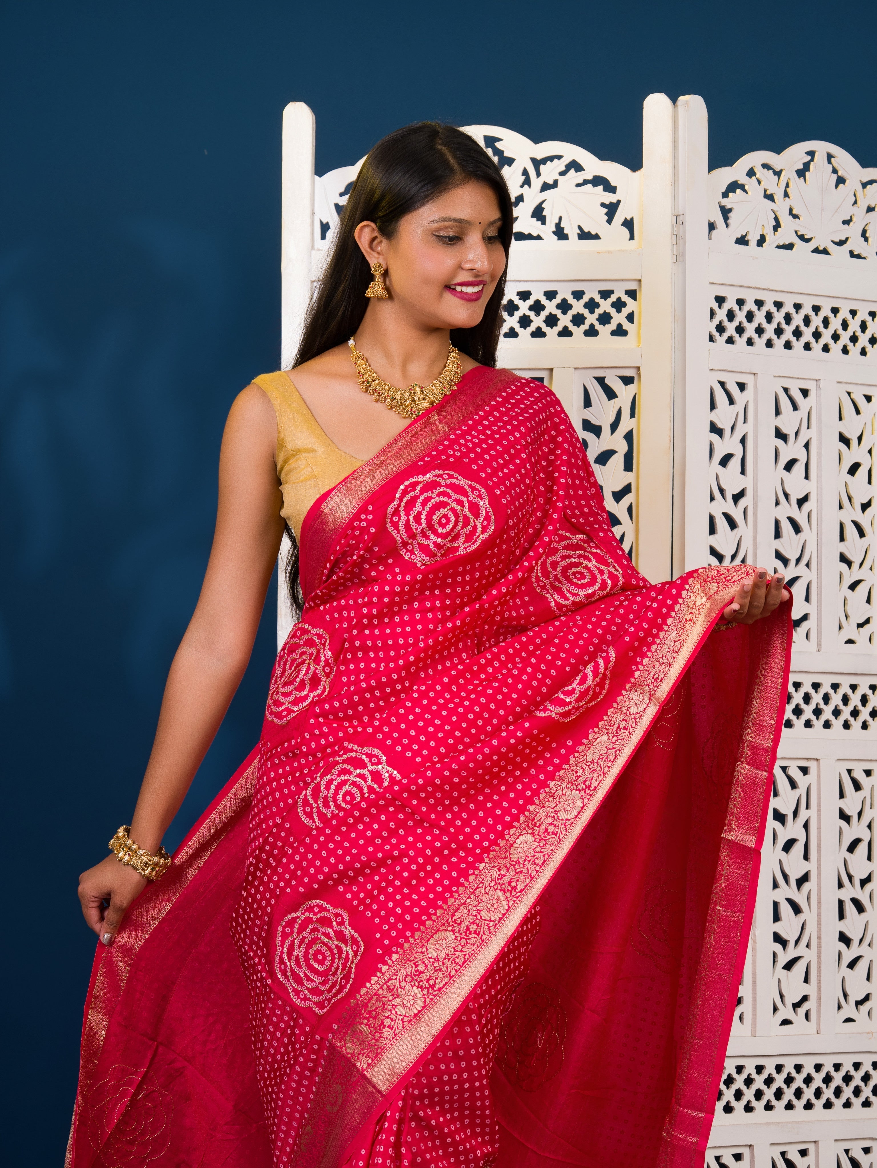 A pink and gold Upada silk saree with Bandhani style embellishments and Zari work,