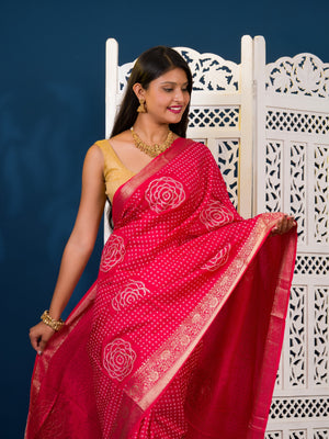 A pink and gold Upada silk saree with Bandhani style embellishments and Zari work,