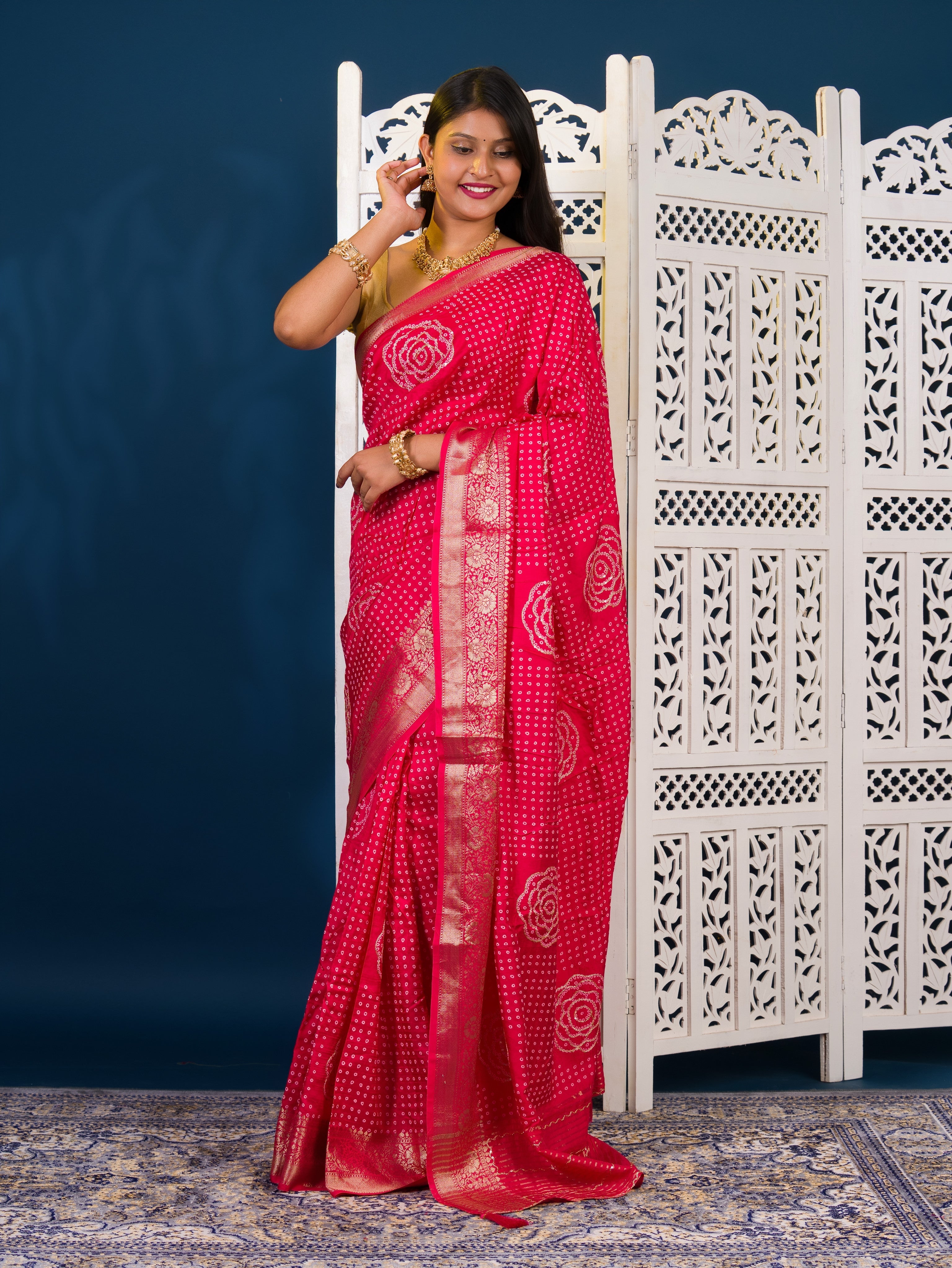 A pink and gold Upada silk saree with Bandhani style embellishments and Zari work,