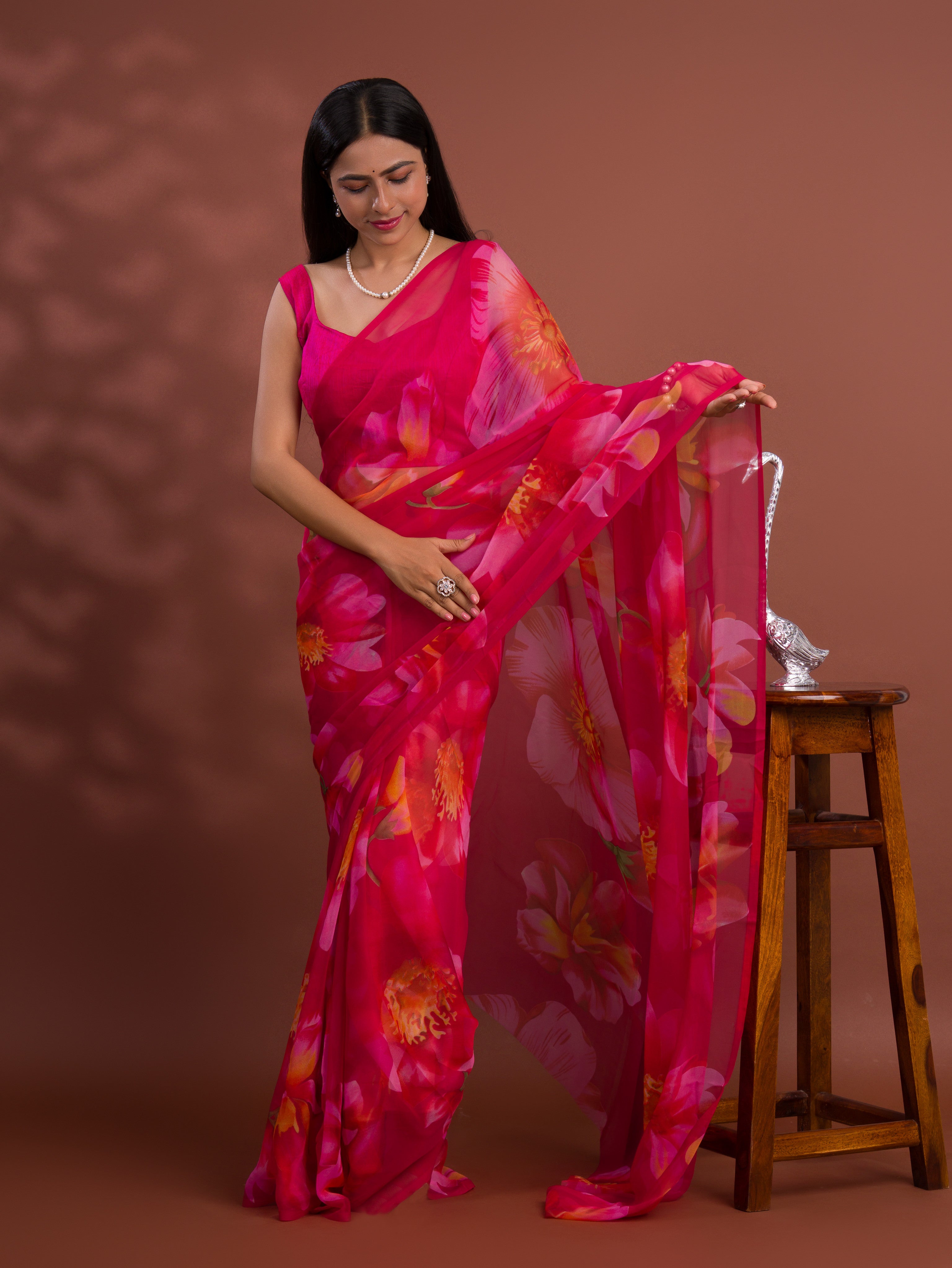 A vibrant pink saree with floral patterns Georgette Flower Printed Style