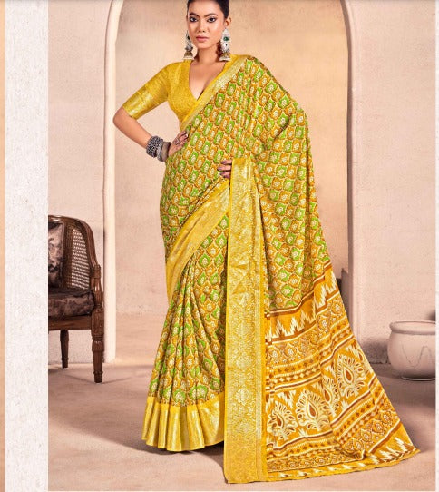A yellow and green georgette saree with floral hand print work.