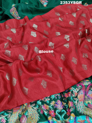 A green saree with a colorful border in Dola Silk Kalamkari Style