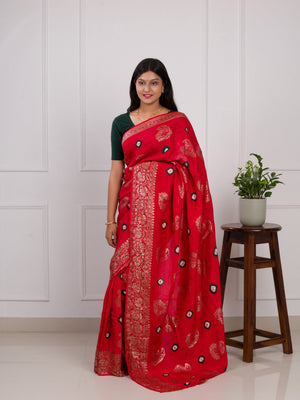A red saree with green patterns with Dola Silk Bandhani Zari Weaving Work