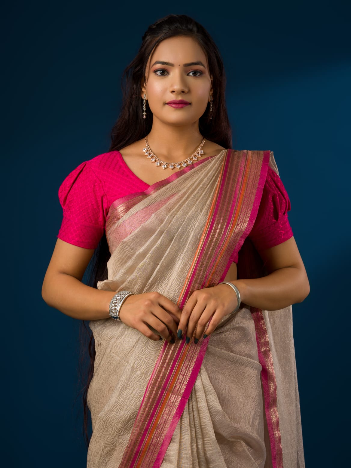 A cream-colored banarasi silk saree