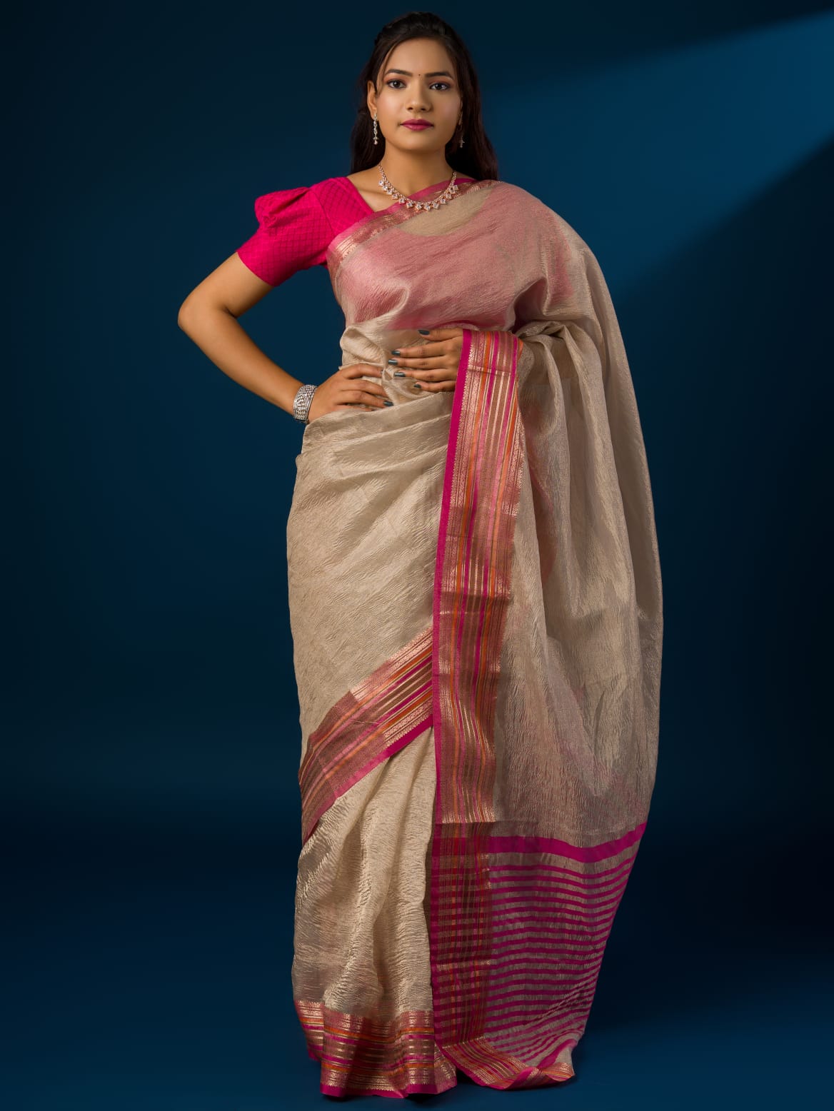 A cream-colored banarasi silk saree