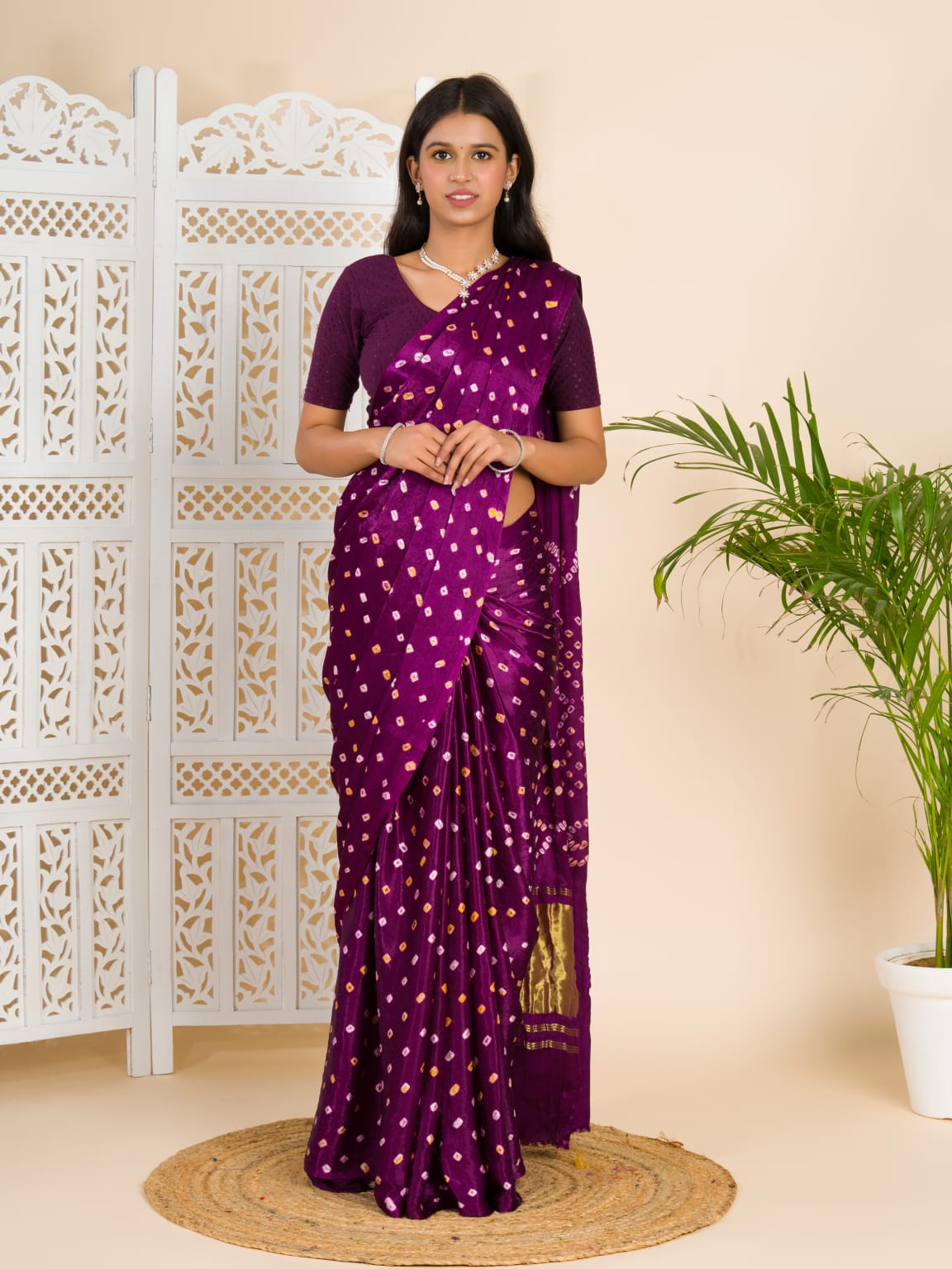 A purple and pink bandhani saree with a lagdi pattern on the pallu,
