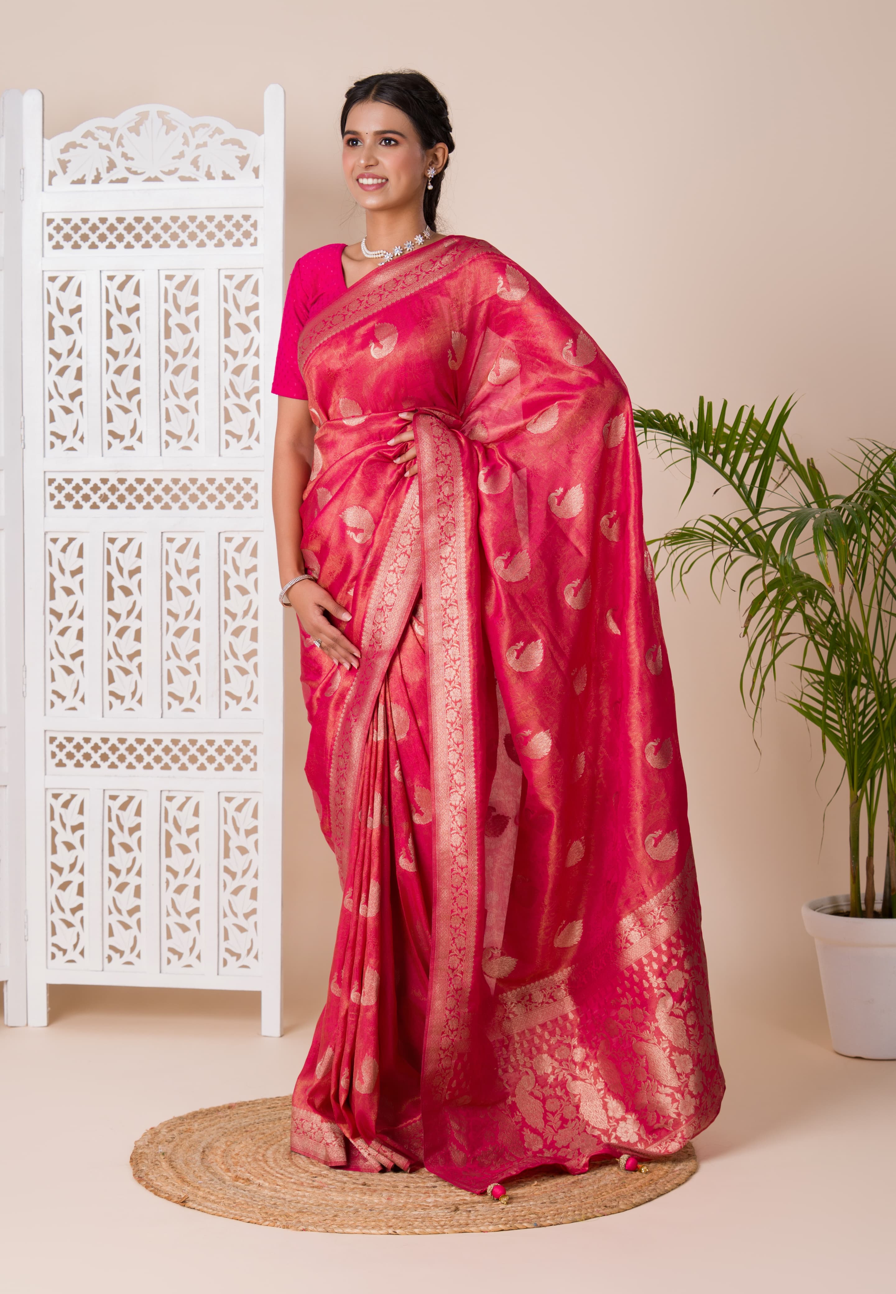 A red and golden Banarasi style saree with zari weaving,