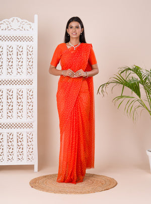 an orange chiffon saree with a bandhani pattern