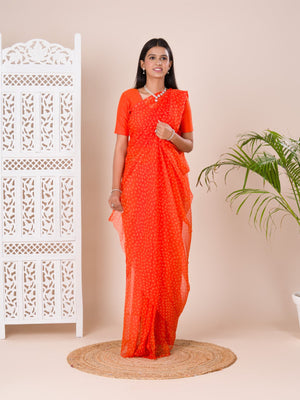an orange chiffon saree with a bandhani pattern