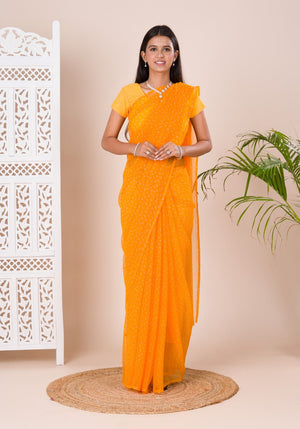 A yellow chiffon saree with a bandhani pattern