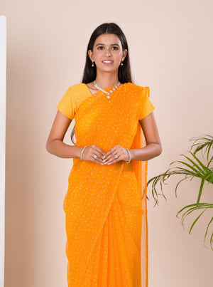 A yellow chiffon saree with a bandhani pattern