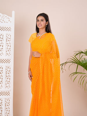 A yellow chiffon saree with a bandhani pattern