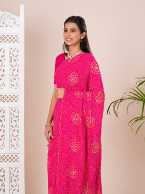 A pink saree with bandhani pattern and aari tari work