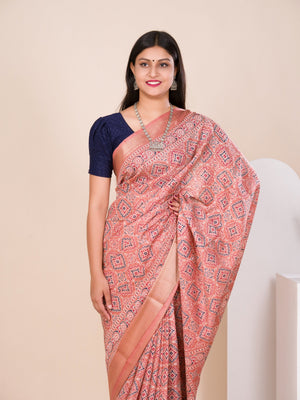 A peach and pink ajrakh style cotton silk saree