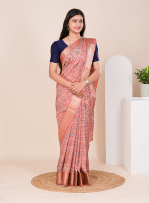 A peach and pink ajrakh style cotton silk saree