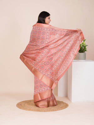 A peach and pink ajrakh style cotton silk saree
