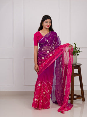 A pink and purple saree with a white pattern under 1000