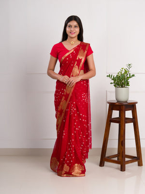A red saree with gold patterns in Georgette Bandhani Style Saree