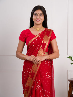 A red saree with gold patterns in Georgette Bandhani Style Saree