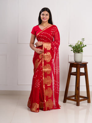 A red saree with gold patterns in Georgette Bandhani Style Saree
