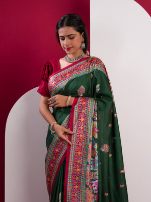 A green saree with a colorful border in Dola Silk Kalamkari Style