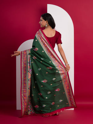 A green saree with a colorful border in Dola Silk Kalamkari Style