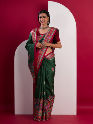 A green saree with a colorful border in Dola Silk Kalamkari Style
