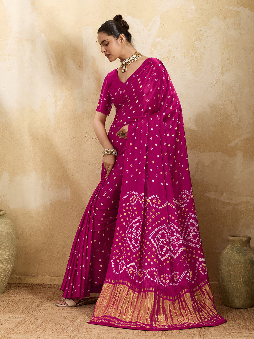 A pink saree with a bandhani pattern and a lagdi pallu design, 