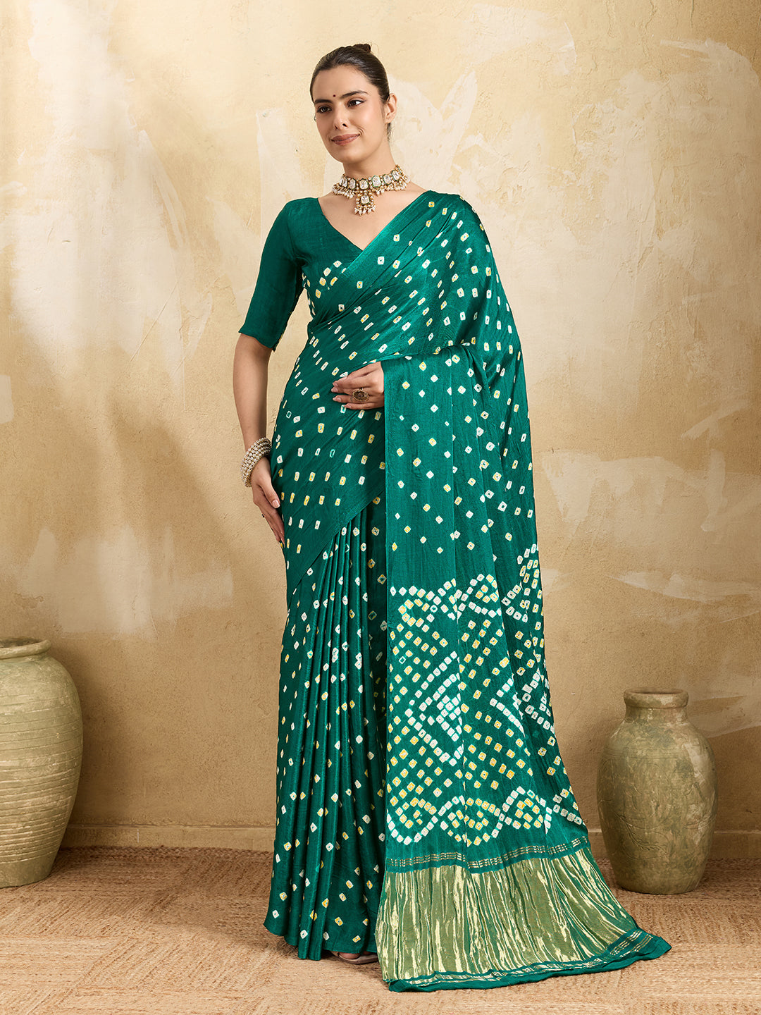  A traditional saree with a bandhani pattern in teal color,