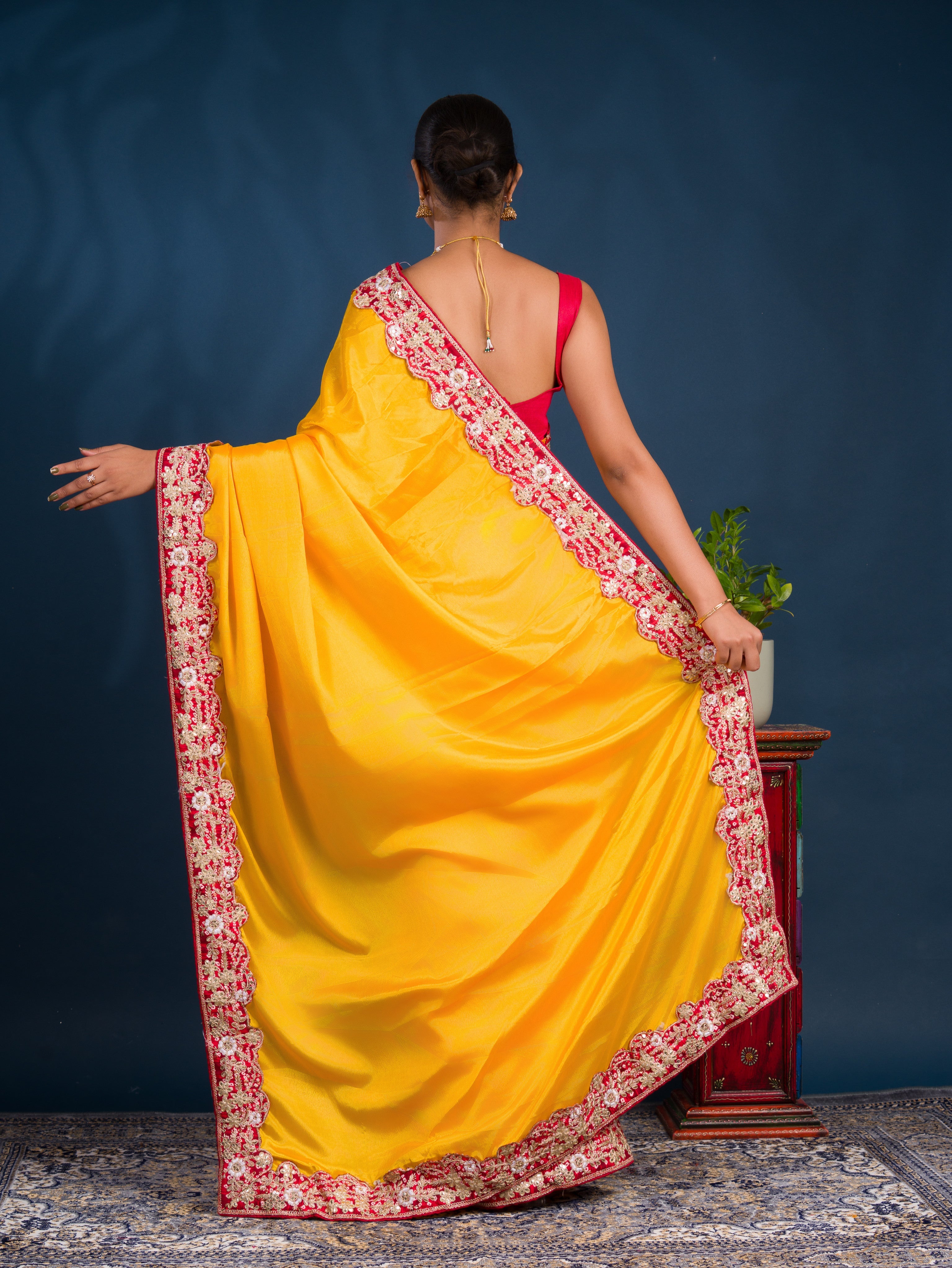 A yellow saree with red border  Chinon Silk Bollywood Style With Sequence Gotapatti Work Saree 