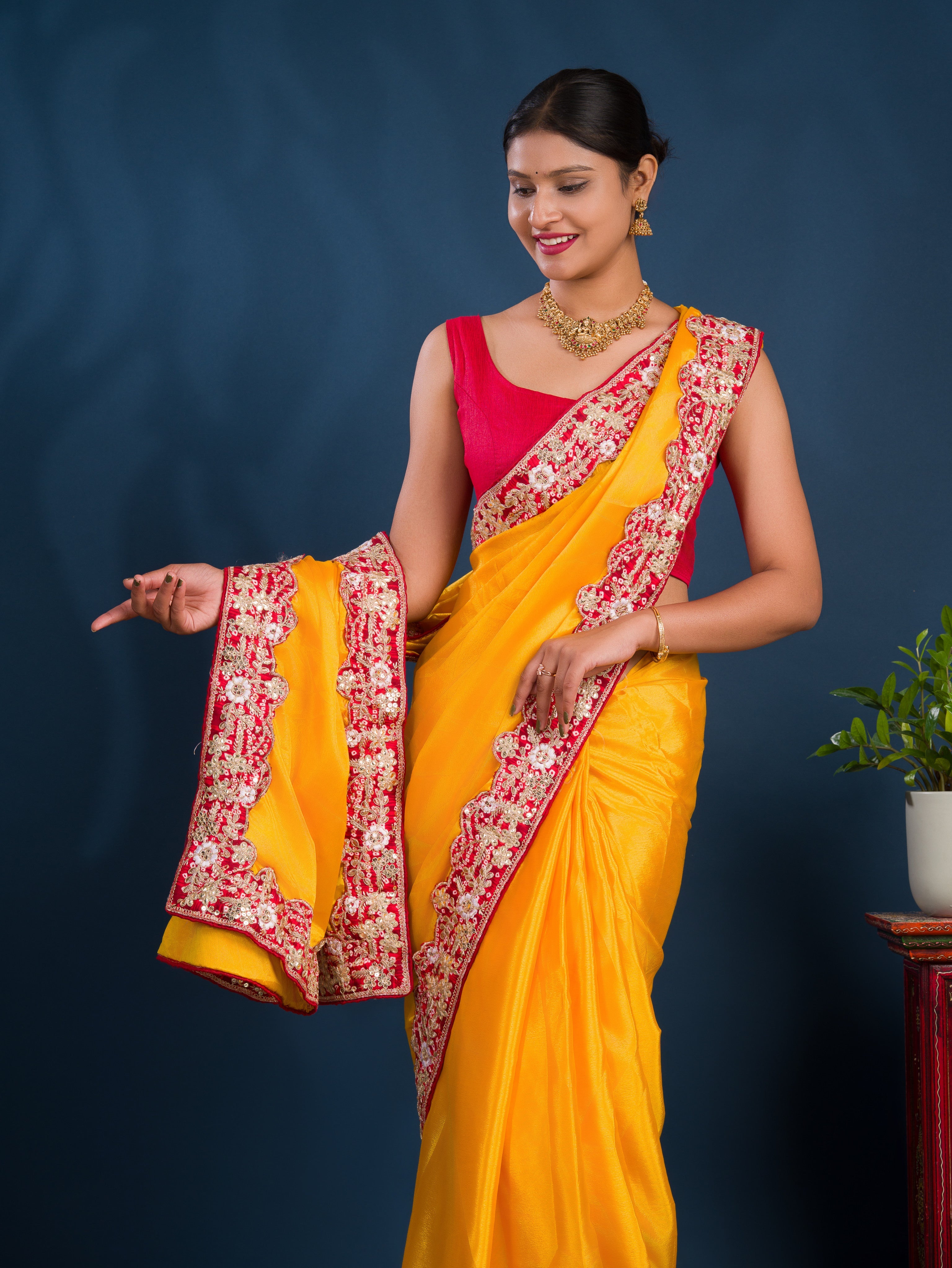 A yellow saree with red border  Chinon Silk Bollywood Style With Sequence Gotapatti Work Saree 
