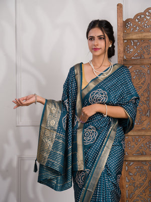 A blue saree with bandhani style embellishments and zari work