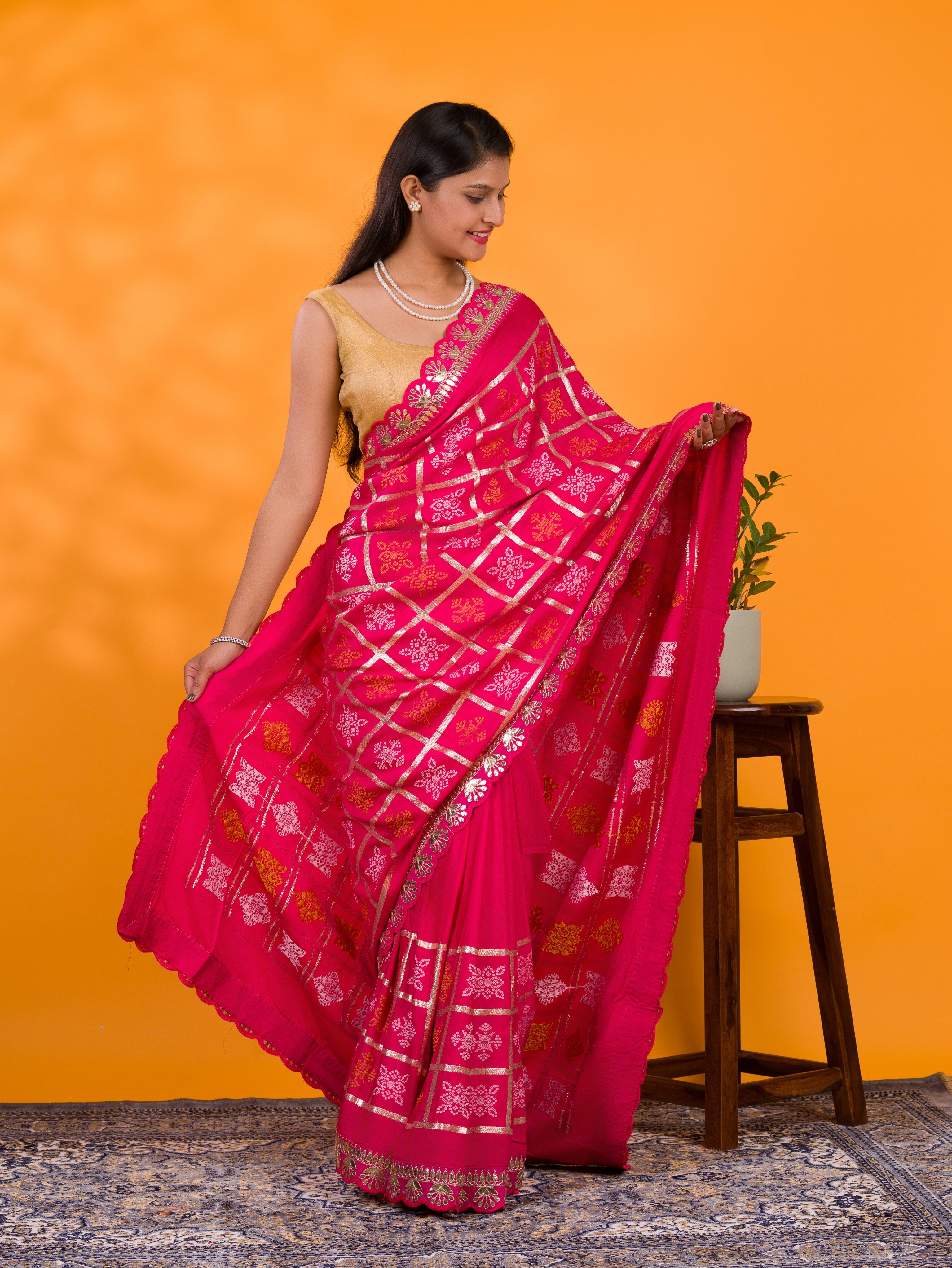 A pink saree with white patterns with  Cotton silk Bandhani Gotapatti Work Saree