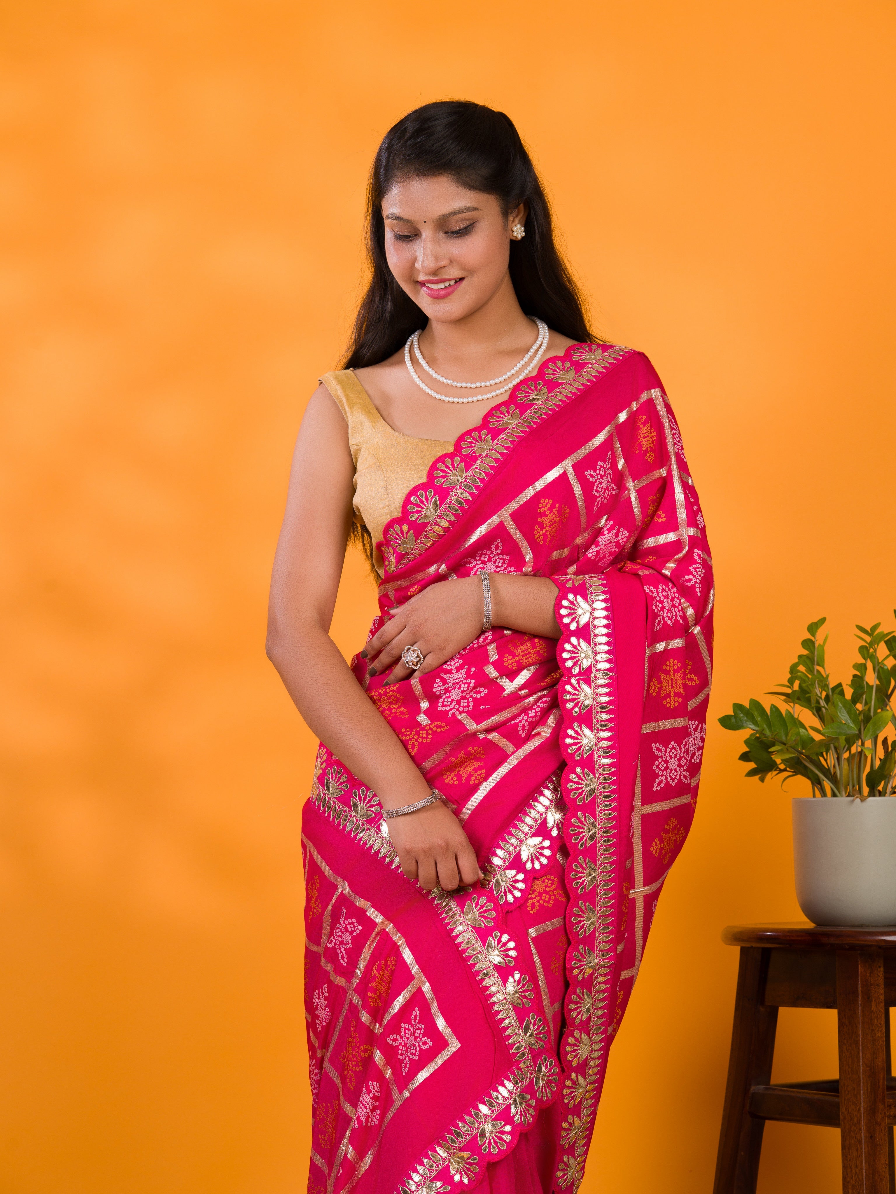 A pink saree with white patterns with  Cotton silk Bandhani Gotapatti Work Saree