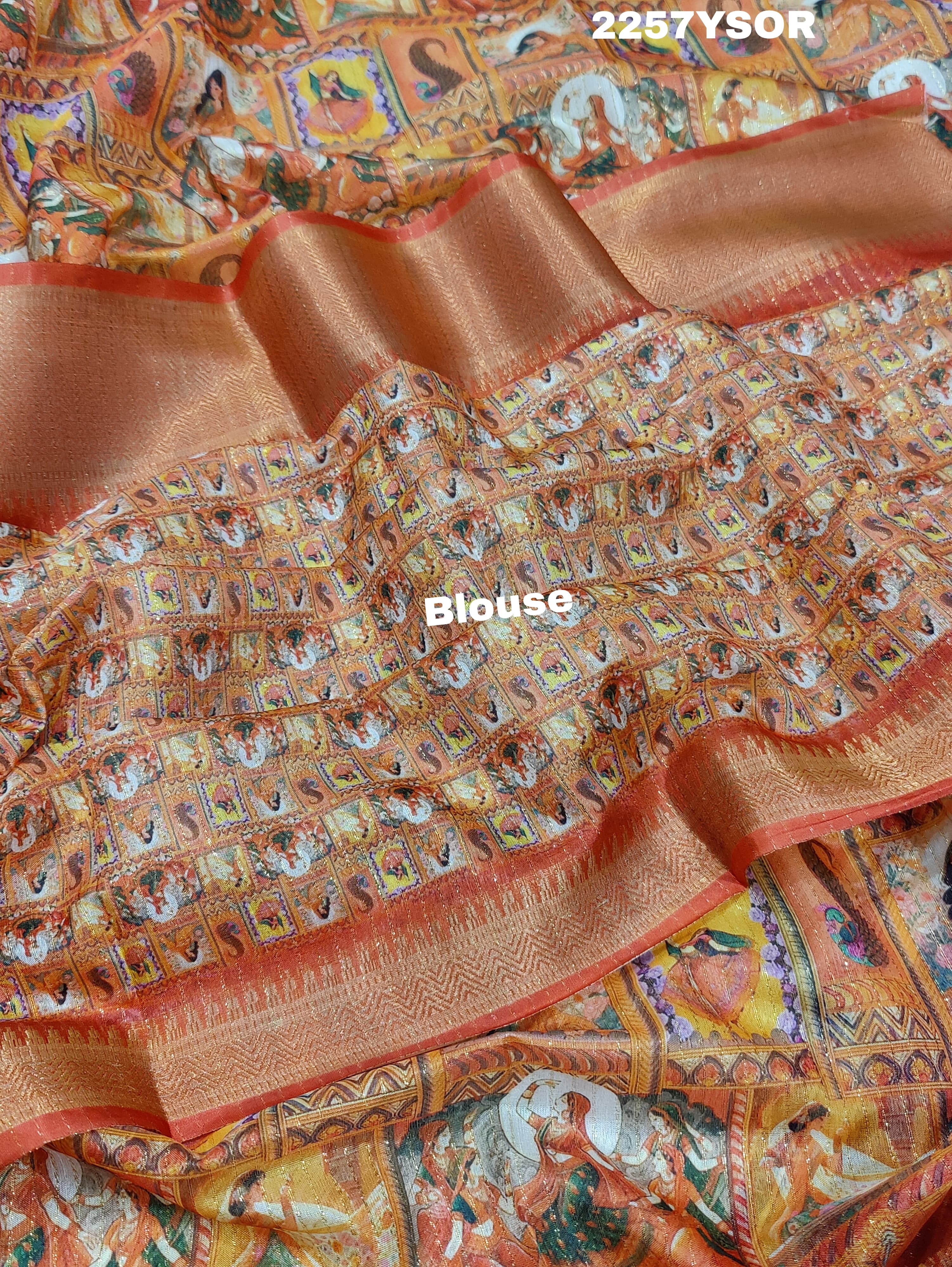 A saree with a kalamkari style pattern in orange and green colors, with zari weaving and a Banarasi border.